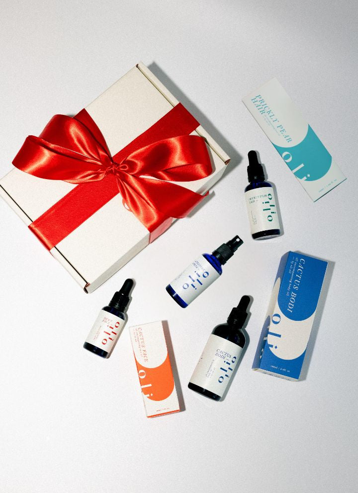 Gift set of skincare, haircare and body products with a decorative box on a white background